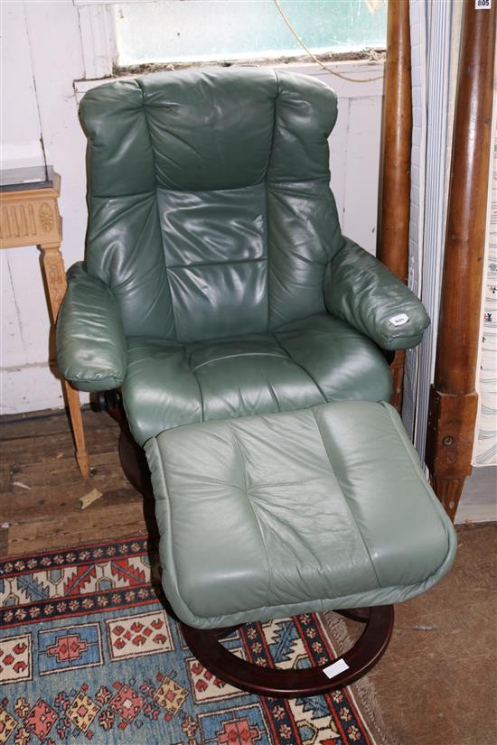 Mahogany green leather reclining armchair and matching stool